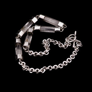 Close-up detail of handmade sterling silver and natural clear quartz crystal bar necklace, showing individual crystal bars set in hand-fabricated silver end caps, connected with jump rings, with handmade belcher chain visible, Thornhill Jewellery