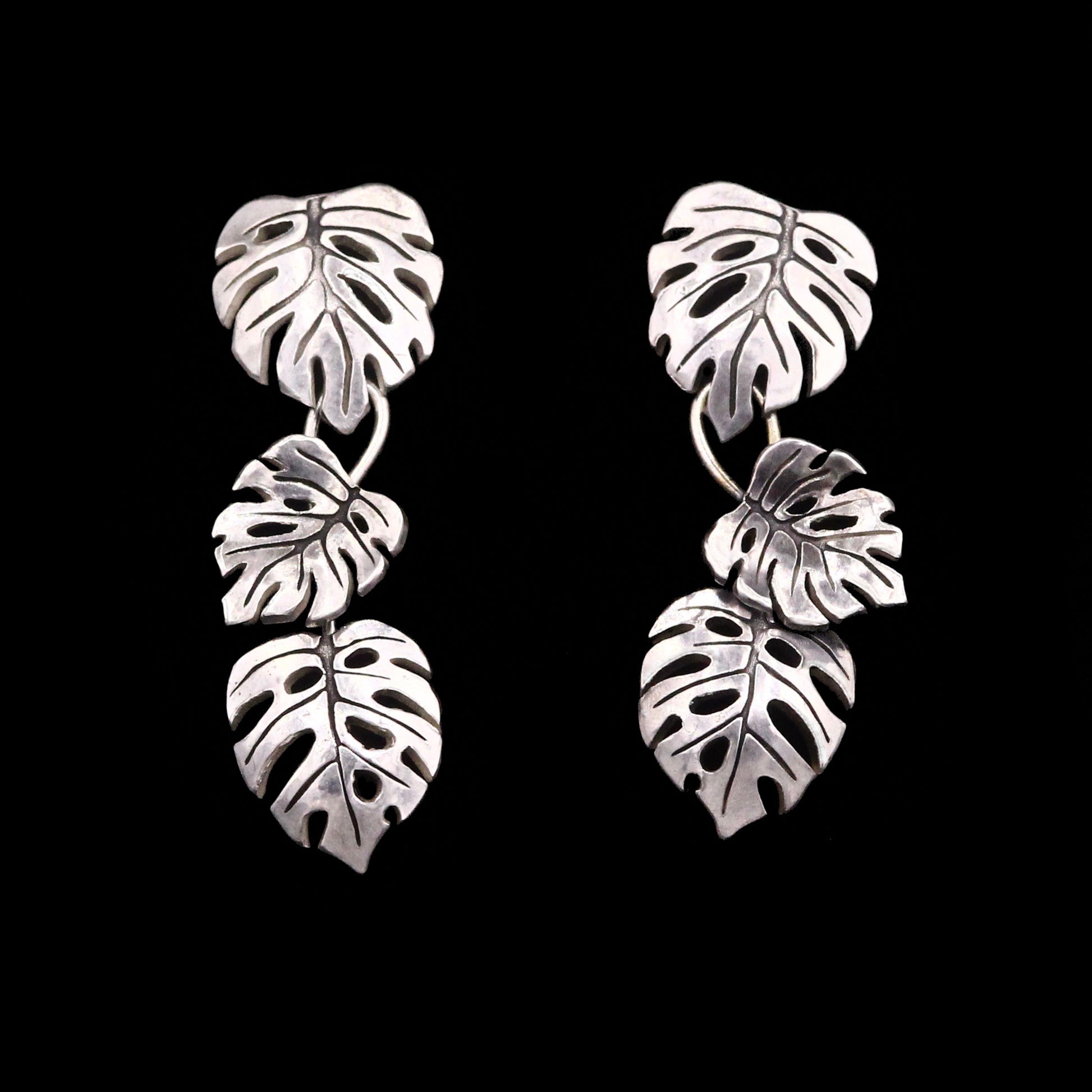 Sterling Silver leaf-shaped earrings. Each earring is composed from 3 monstera leaves.