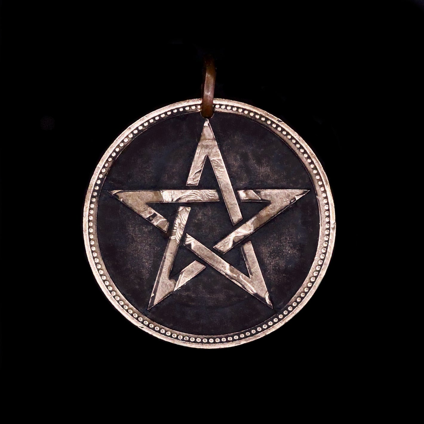 Copper Penny coin pendant engraved with star on dark background, modern interpretation of trench art, Ade by Thornhill Jewellery
